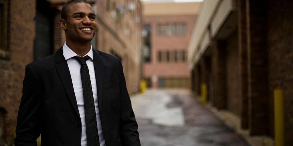 Anti-Money Laundering | Know Your Customer 4 smiling man standing between brown concrete buildings at daytime